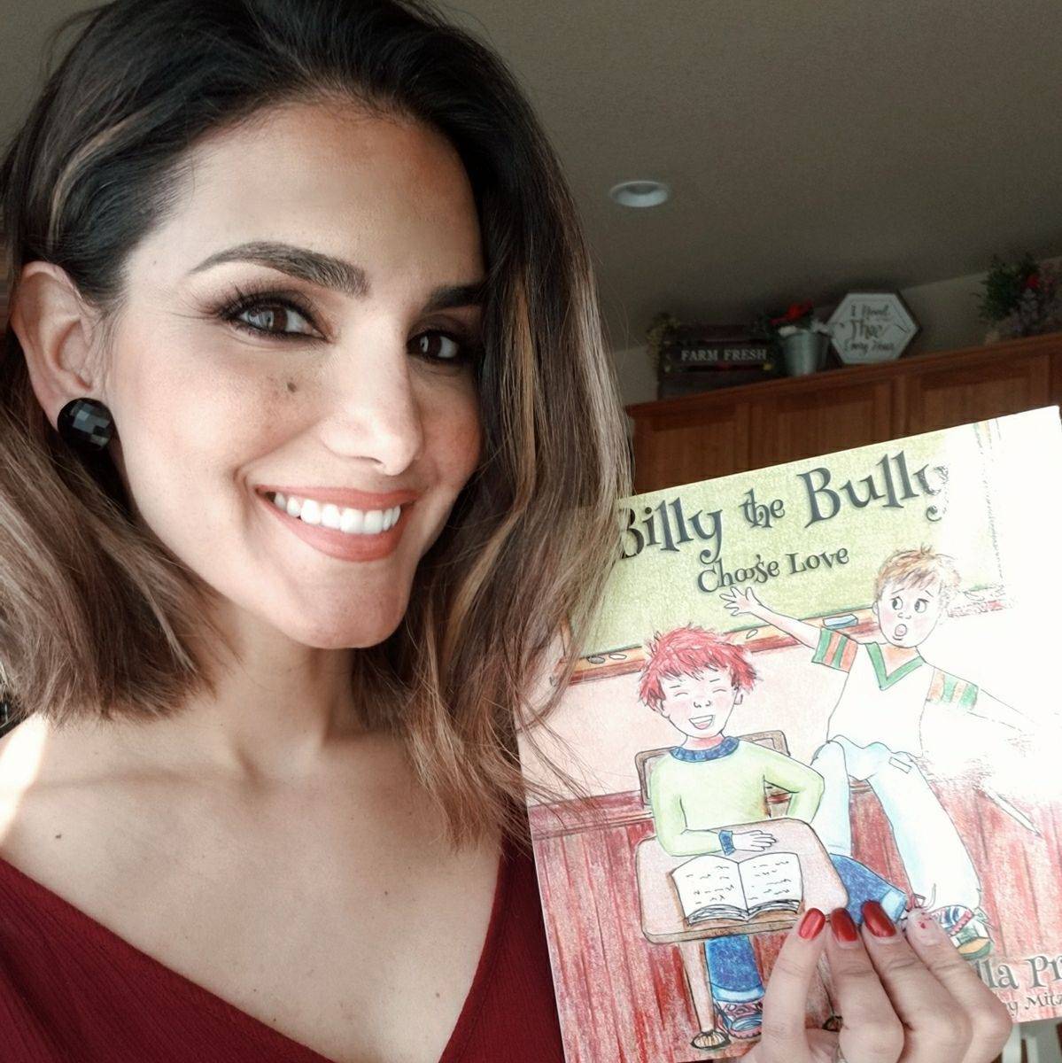 Priscilla Pruitt holding her book Billy the Bully: Choose Love