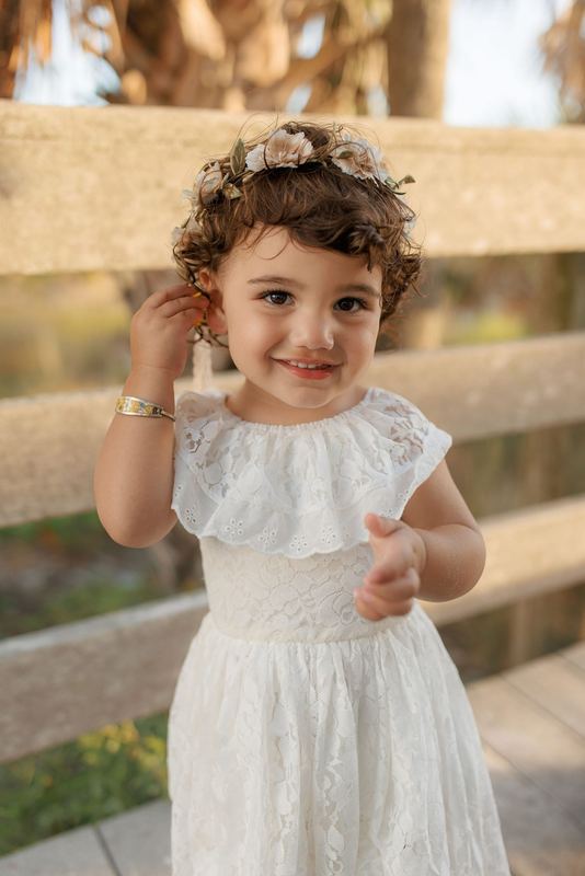Elle Shaddai Joy Pruitt at almost two years old in white lace dress with flower crown