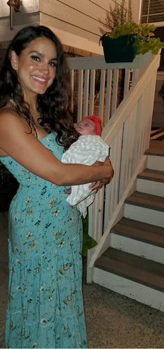 Priscilla holding newborn Elle on the porch