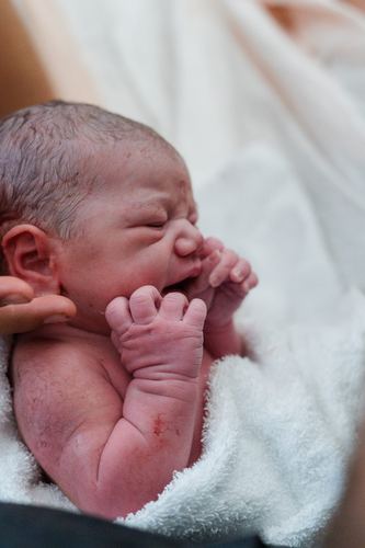 Elle Shaddai Joy Pruitt — newborn, wrapped in white