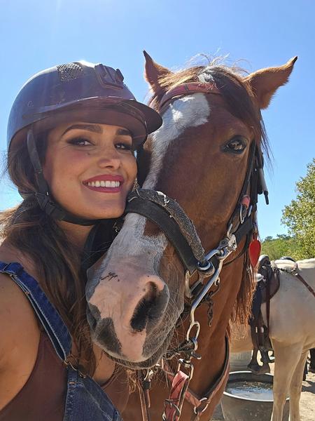 Priscilla Pruitt with a horse after a day's ride