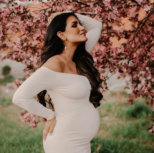 Priscilla Pruitt maternity photo among cherry blossoms