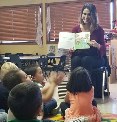 Priscilla reading to children at the orphanage